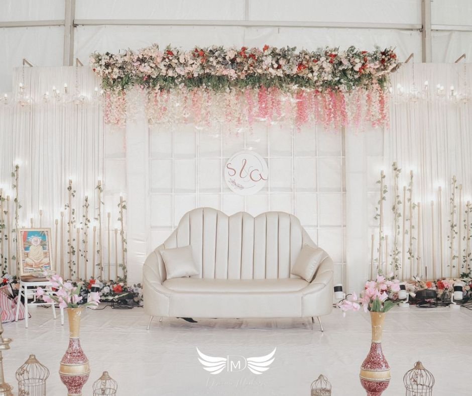 Luxurious stage decoration with floral drapes and LED lighting by an Event Management Company in Kollam